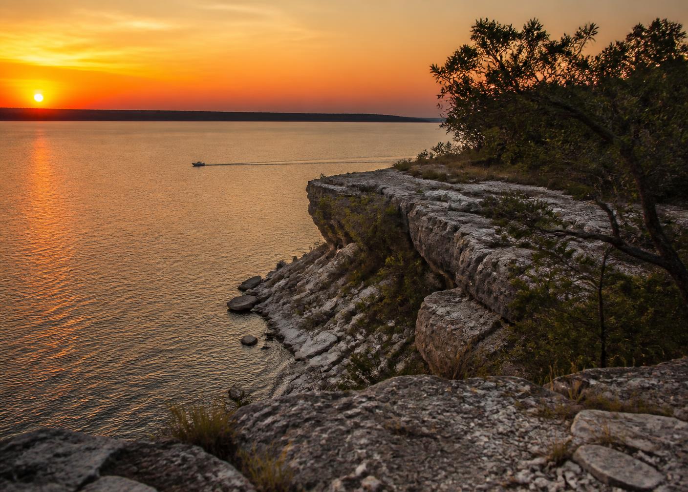 Rocky shoreline and sunset over Lake Texoma near Denison, Texas